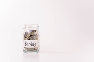Pile of money coins in piggy bank with white background, saving money and financial concept, copy space