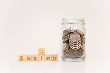 Pile of money coins in bottle or piggy bank with white background, saving money and financial concept, copy space