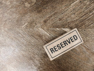 The isolated wording of Reserved on the wooden background
