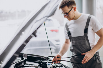 Repair man at car service doing car check up