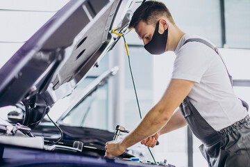 Repair man making car service