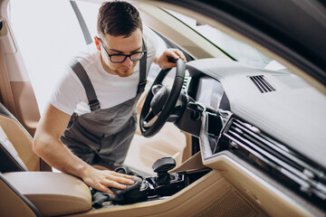 Man polishing car inside at car service