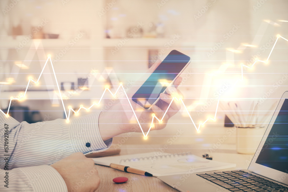 Poster double exposure of man's hands holding and using a digital device and forex graph drawing. financial