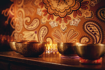 beautiful tibetan bowl on a wooden shelf, ceremonial space.