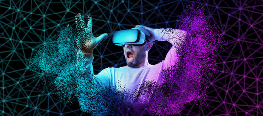 Web banner of metaverse. Portrait of amazement disappearing bald and bearded man in VR glasses....