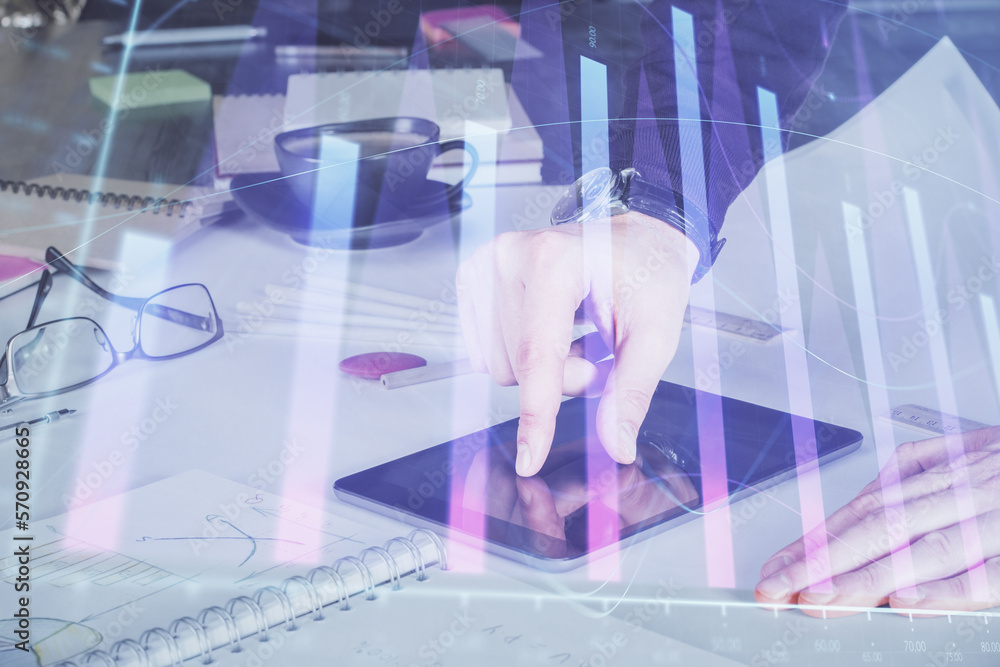 Poster double exposure of man's hands holding and using a digital device and forex graph drawing. financial