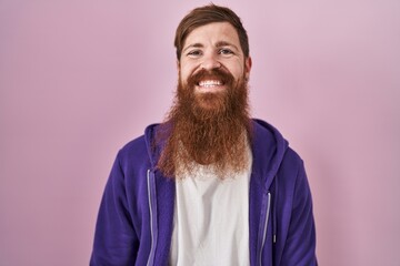 Caucasian man with long beard standing over pink background with a happy and cool smile on face. lucky person.