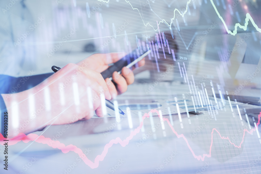 Poster double exposure of man's hands holding and using a phone and financial chart drawing. market analysi