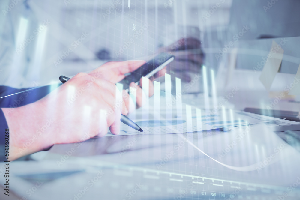 Poster double exposure of man's hands holding and using a phone and financial chart drawing. market analysi