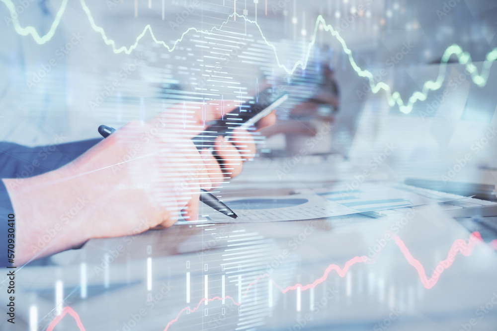 Poster double exposure of man's hands holding and using a phone and financial chart drawing. market analysi