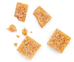 Brown sugar cubes isolated on white background. Cane sugar cubes with crumbs  Top view. Flat lay.