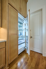 Open door of built in refrigerator in new home - 570932237