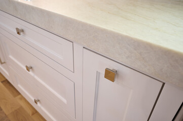Gold hardware on white kitchen cabinets - 570932269