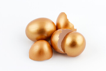 Easter concept. Heap of golden egg with empty broken golden eggs isolated on white background