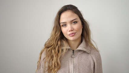 Young beautiful hispanic woman standing with relaxed expression over isolated white background