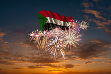 Flag of Sudan and Holiday fireworks in sky