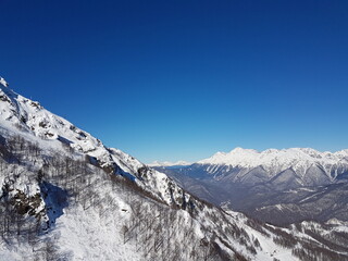 Fototapeta na wymiar Mountain peaks, blue sky, winter