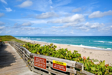 Wood boardwalk leading to the beach at John D. MacArthur Beach State Park in Palm Beach County, Florida. 