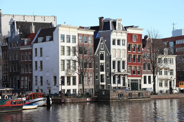 Fototapeta na wymiar Amsterdam Staalkade Street View with Typical Architecture and Boats, Netherlands