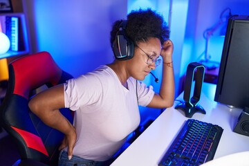African american woman streamer stressed suffering for backache at gaming room © Krakenimages.com