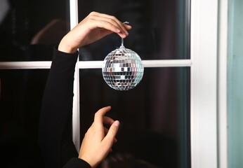 woman holding a glass disco ball