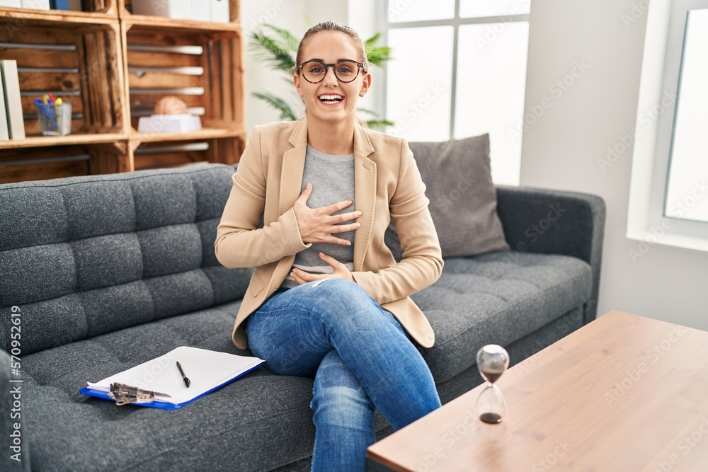 Canvas Prints young woman working at consultation office smiling and laughing hard out loud because funny crazy jo