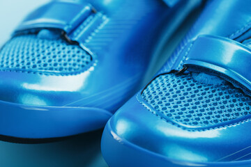 Blue bicycle shoes on a blue background