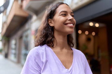 Young african american woman smiling confident looking to the side at street