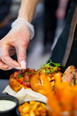 woman chef hands in gloves cooking sandwich Set bruschetta with tuna, cheese, roastbeef, vegetables and french fries on kitchen