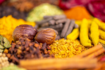 Various spices, peppers and herbs close-up top view. Eastern spice market. A set of peppers and spices for cooking.
