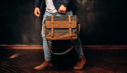 Man hold brown canvas organizer bag in hand