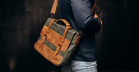 Man with duffle bag on shoulder. leather and canvas bag - obrazy, fototapety, plakaty
