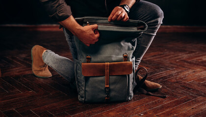 Man's hands with Canvas Backpack accessories. Hand made backpack for travelers.