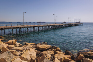 Fototapeta premium Tourists pier in Molos sea front park of Limassol city in Cyprus island country