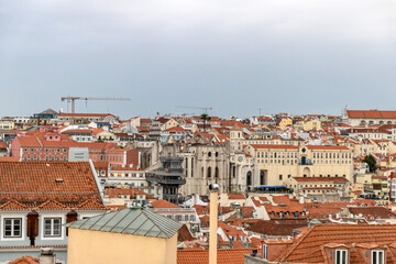 Fototapeta na wymiar Red clay rooftops of Lisbon Portugal with landmarks