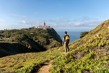 Man hiking near Cabo Da Roca lighthouse in Sintra Mountain Range in Portgual