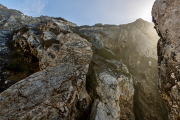 Fototapeta na wymiar Sunny Rock cliffs from Praia da Ursa beach on coast of Portugal