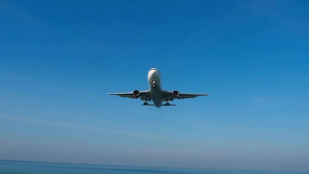 Jet plane descending to landing in the blue sky. Tourism and travel concept