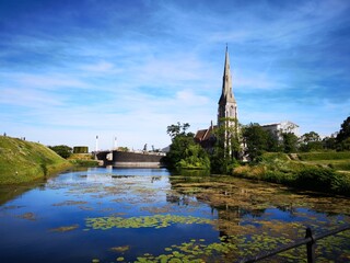 pond with church