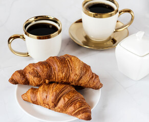 Morning with a cup of coffee and croissants. On a white background. Breakfast.