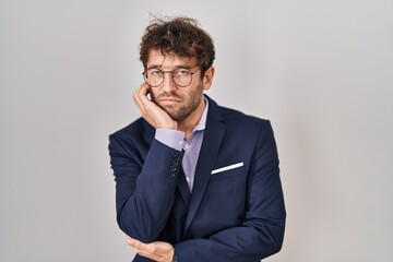 Hispanic business man wearing glasses thinking looking tired and bored with depression problems with crossed arms.