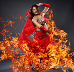 Arabic lady belly dancer dancing with fire