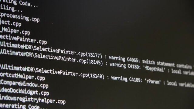 Computer Source Code scrolls on a screen.