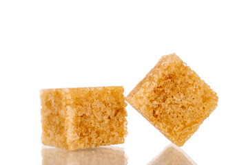 Two cubes of brown sugar, macro, isolated on white background.