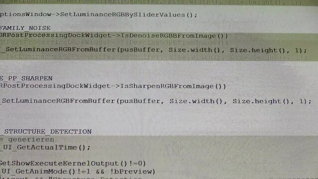 Computer Source Code scrolls on a screen.