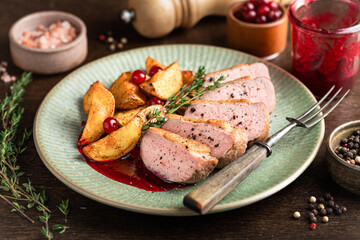 Duck breast steak with potatoes and berry sauce