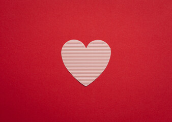 Paper heart on a red background