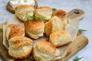 Fresh baked home made  Mini cheese puff pastries and cream  spread cheese.Cheese pie with phyllo pastry and herbs