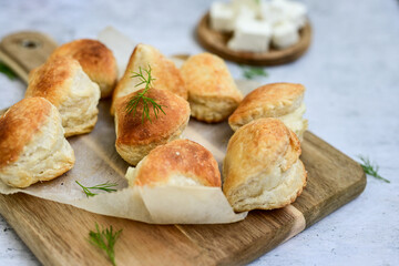 Fresh baked home made  Mini cheese puff pastries and cream  spread cheese.Cheese pie with phyllo pastry and herbs
