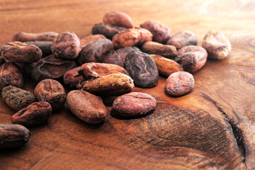 Cocoa beans and heap of Cocoa powder on a wooden background